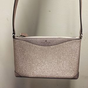 A rose gold shimmer cross body bag by Kate Spade